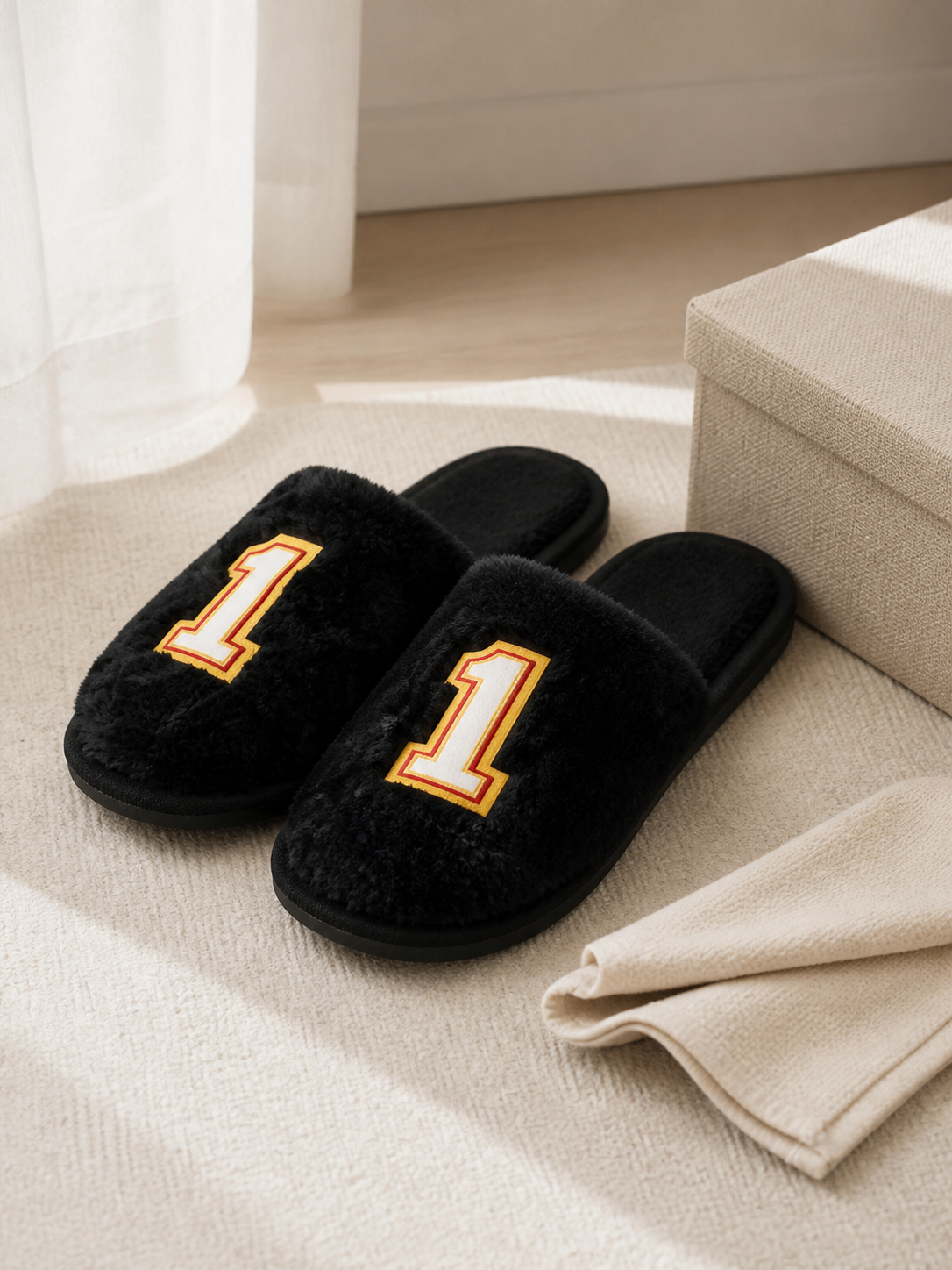 TravelKhushi black plush number-one home slippers beside a care cloth and storage box indoors