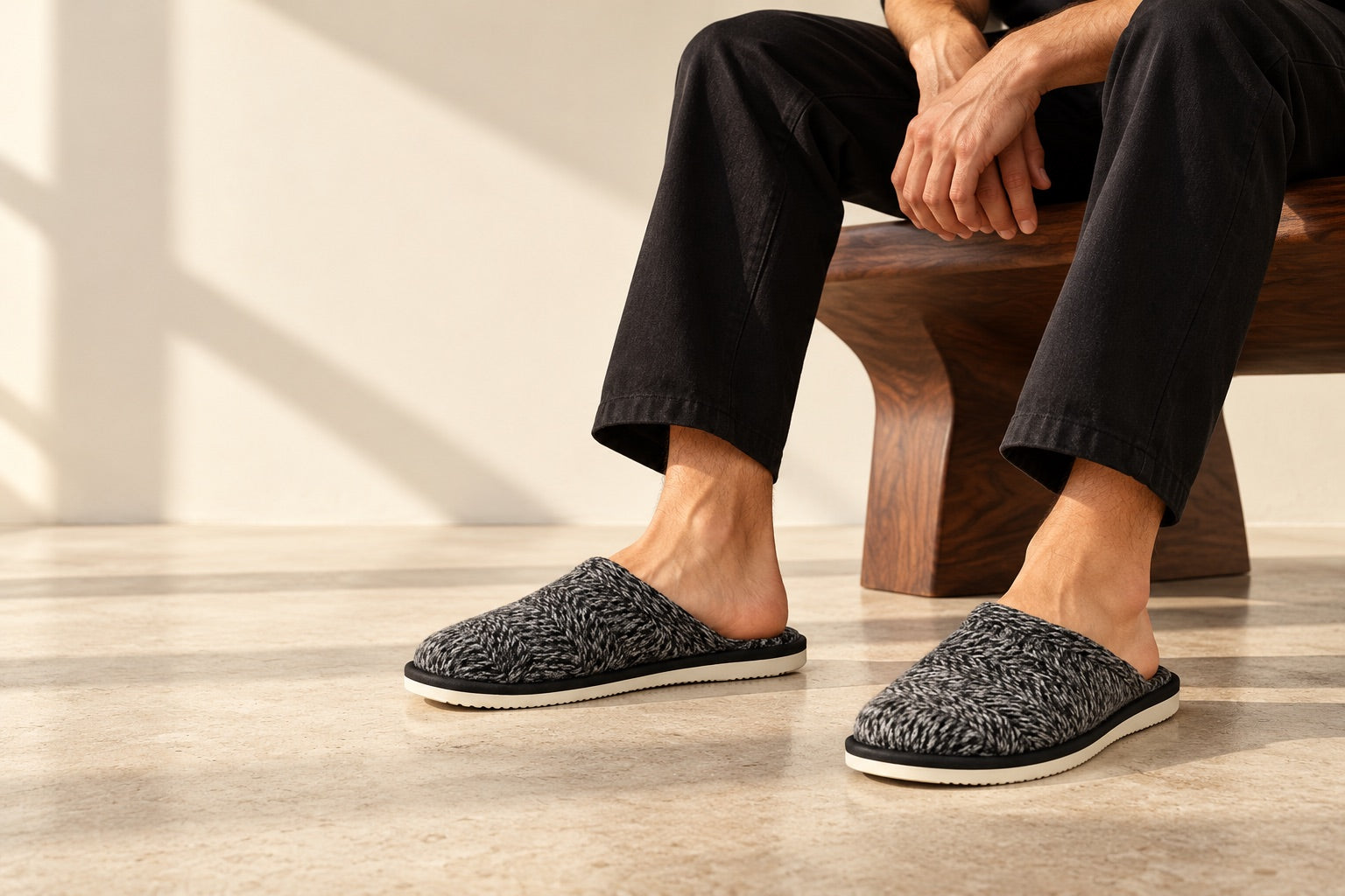 Grey knit TravelKhushi slippers styled with relaxed black trousers